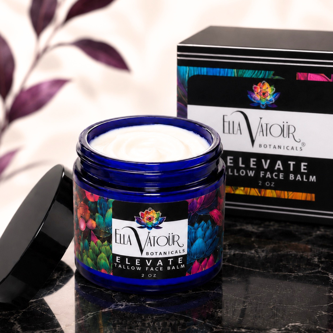 A jar of Ella Vairo Botanicals Elevate Clay Face Balm with white cream inside a cobalt blue jar, shown with its black lid and branded box on a dark marble surface.