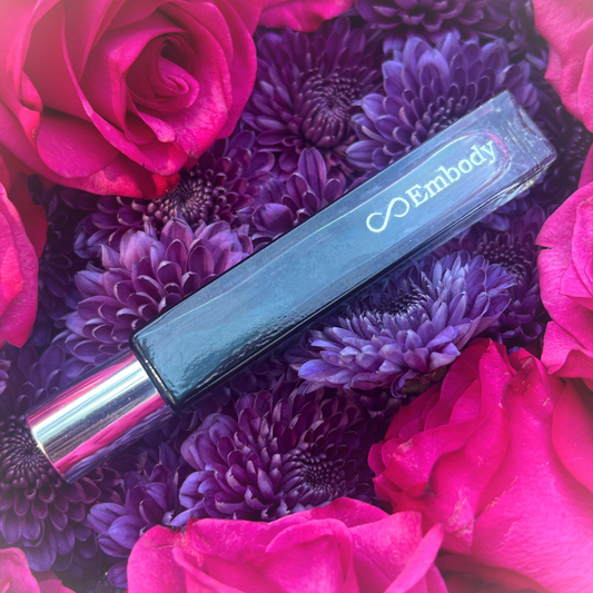 Close-up of the EMBODY 10ml glass roller bottle, featuring handcrafted botanical oils designed for intentional daily wear.